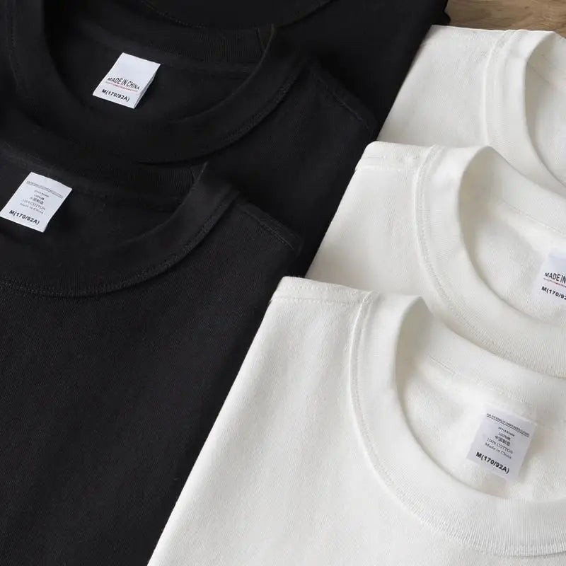 COMFORTH black and white crew neck t-shirts made of 100% cotton, shown layered.