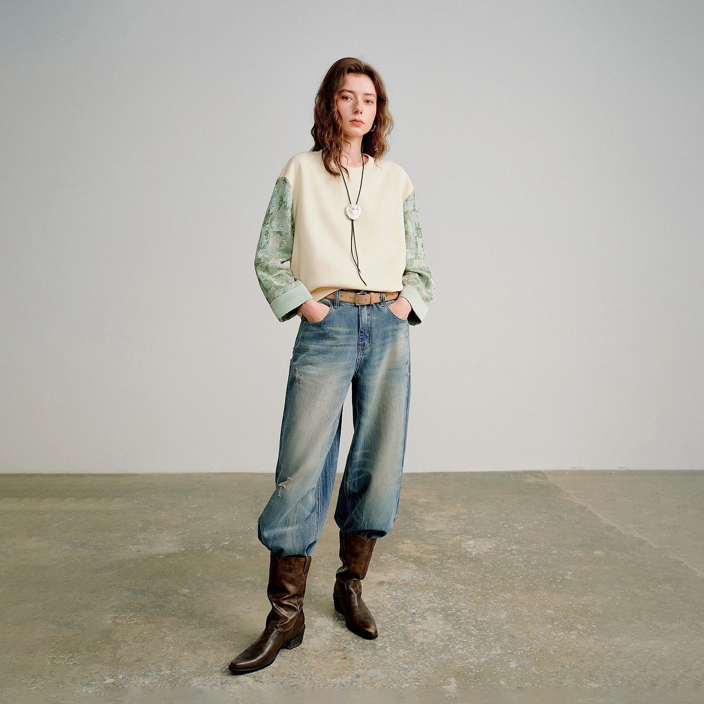 COMFORTH cream cotton blend crew neck sweatshirt with textured sage green contrasting sleeves and relaxed fit.