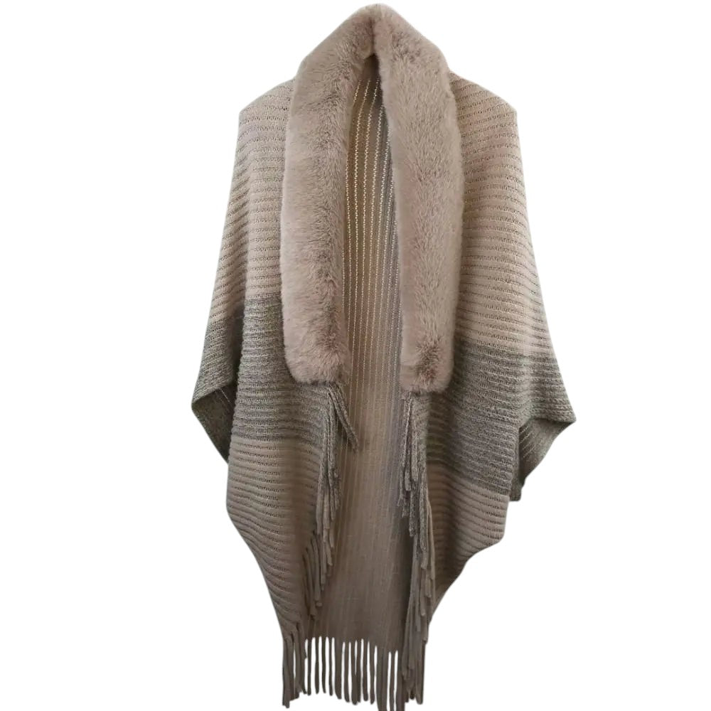 COMFORTH faux fur trimmed knit poncho wrap in beige with fringe detail and open front.