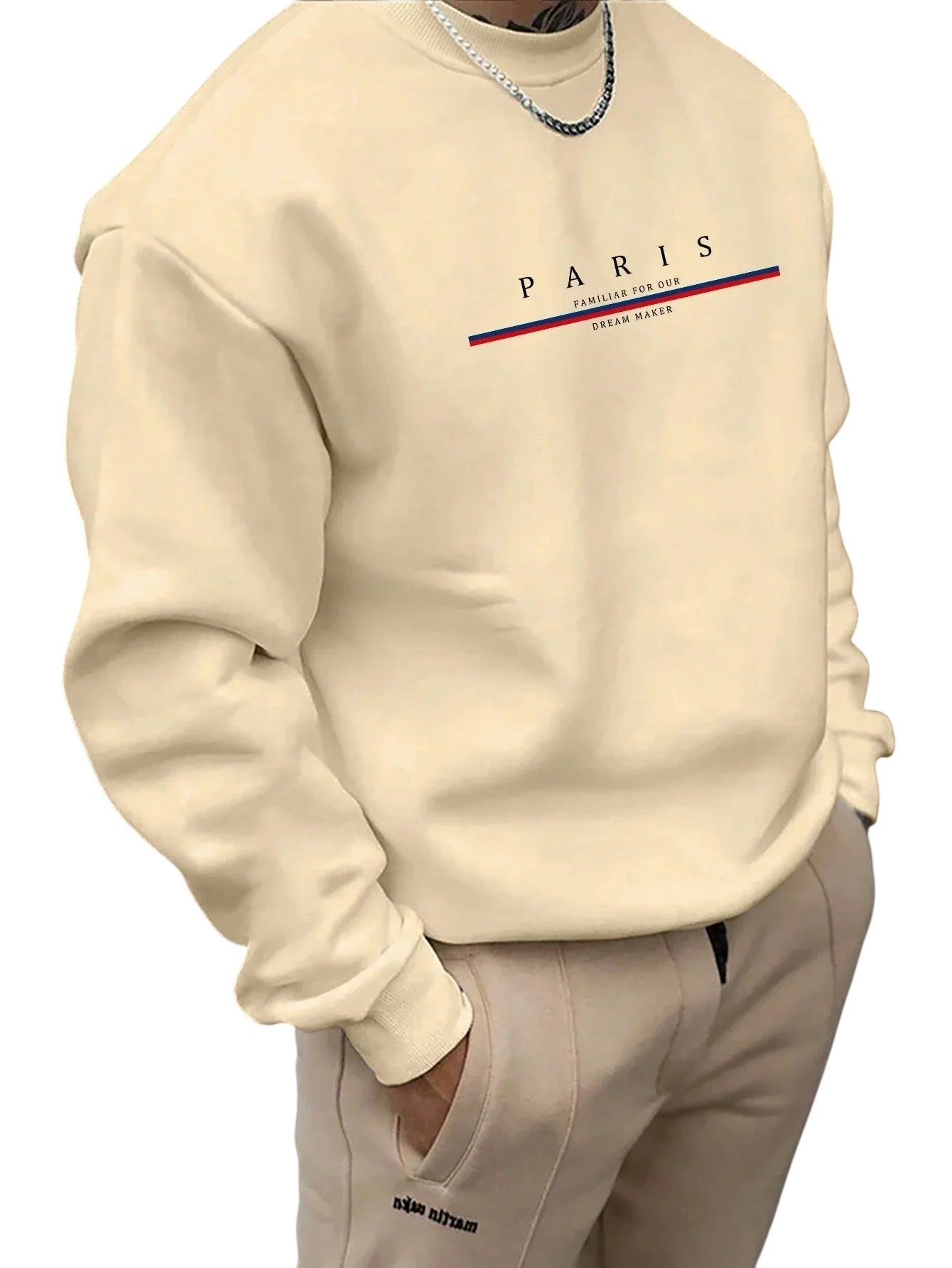COMFORTHere cream crewneck sweatshirt with PARIS graphic design and red/blue stripe detail. Relaxed fit, crew neck, long sleeves.