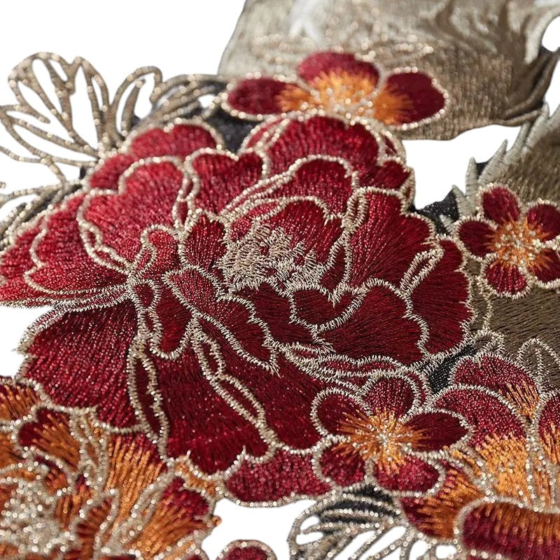 COMFORTS embroidered bomber jacket with floral accents in black and cream, featuring red and pink peonies.