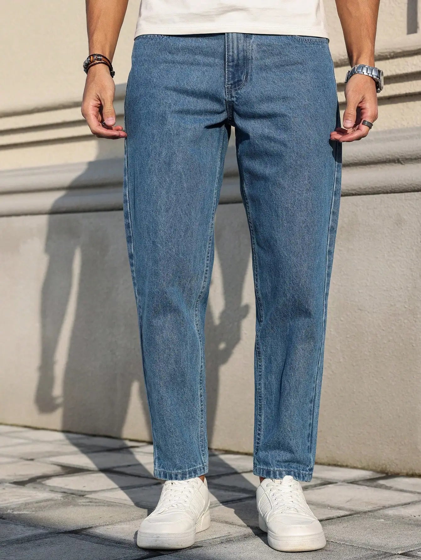 Men's jeans are made of classic blue denim fabric with a loose fit, making them an indispensable versatile item in the wardrobe. Blue