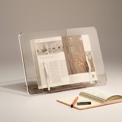 COMFORTH Clear acrylic book stand for hands-free reading, adjustable and foldable. Features a clear plastic design with page holders.