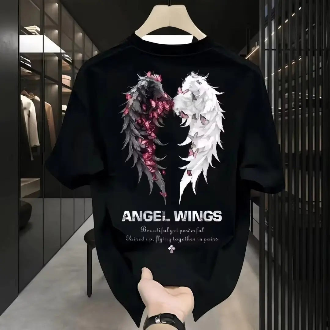 COMFORTH black cotton t-shirt with split angel wings graphic and floral accents. Features text: ANGEL WINGS.