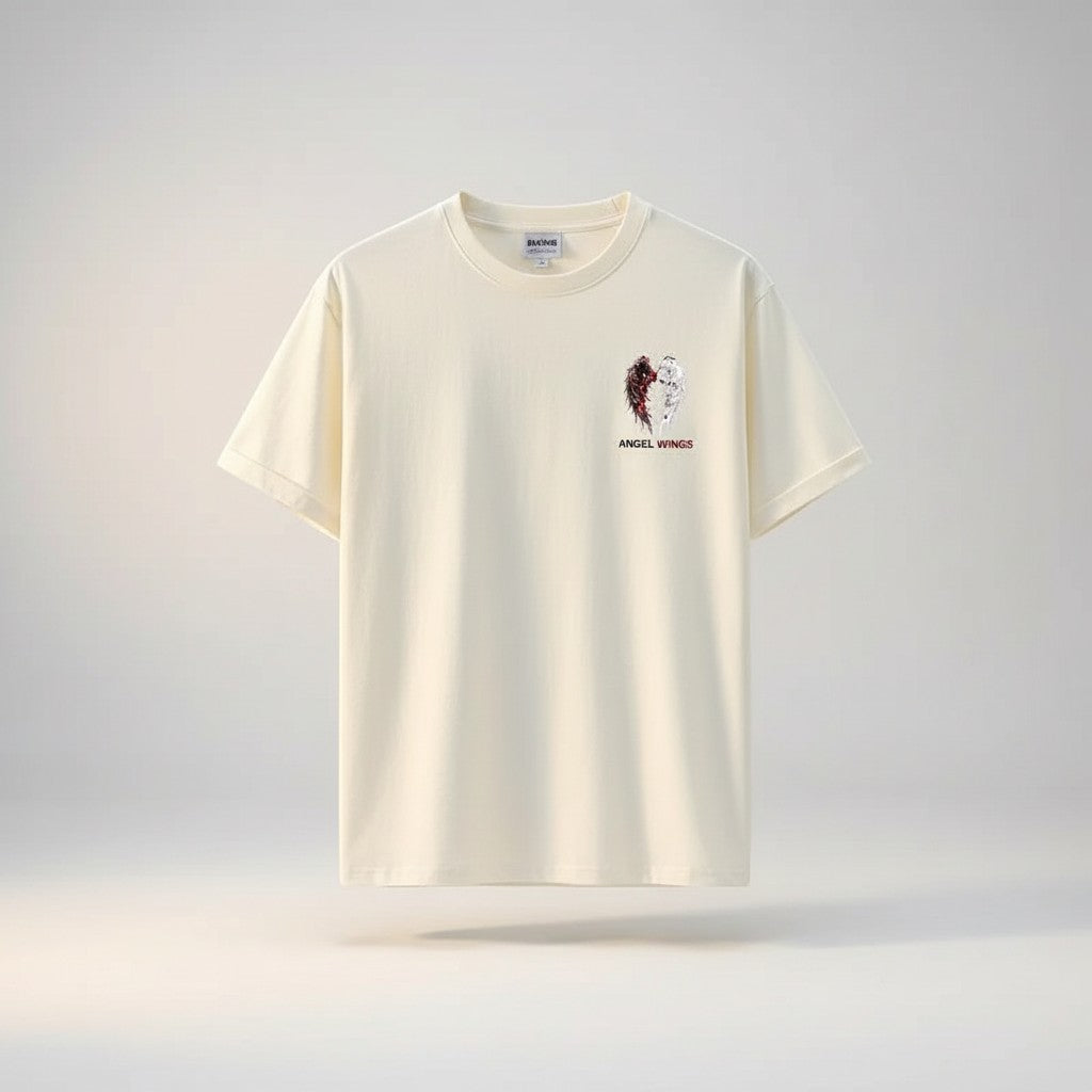 COMFORTH Angel Wings Graphic T-Shirt in cream cotton, featuring a split angel wing design with dark and white feathers.