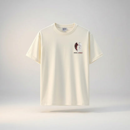COMFORTH Angel Wings Graphic T-Shirt in cream cotton, featuring a split angel wing design with dark and white feathers.