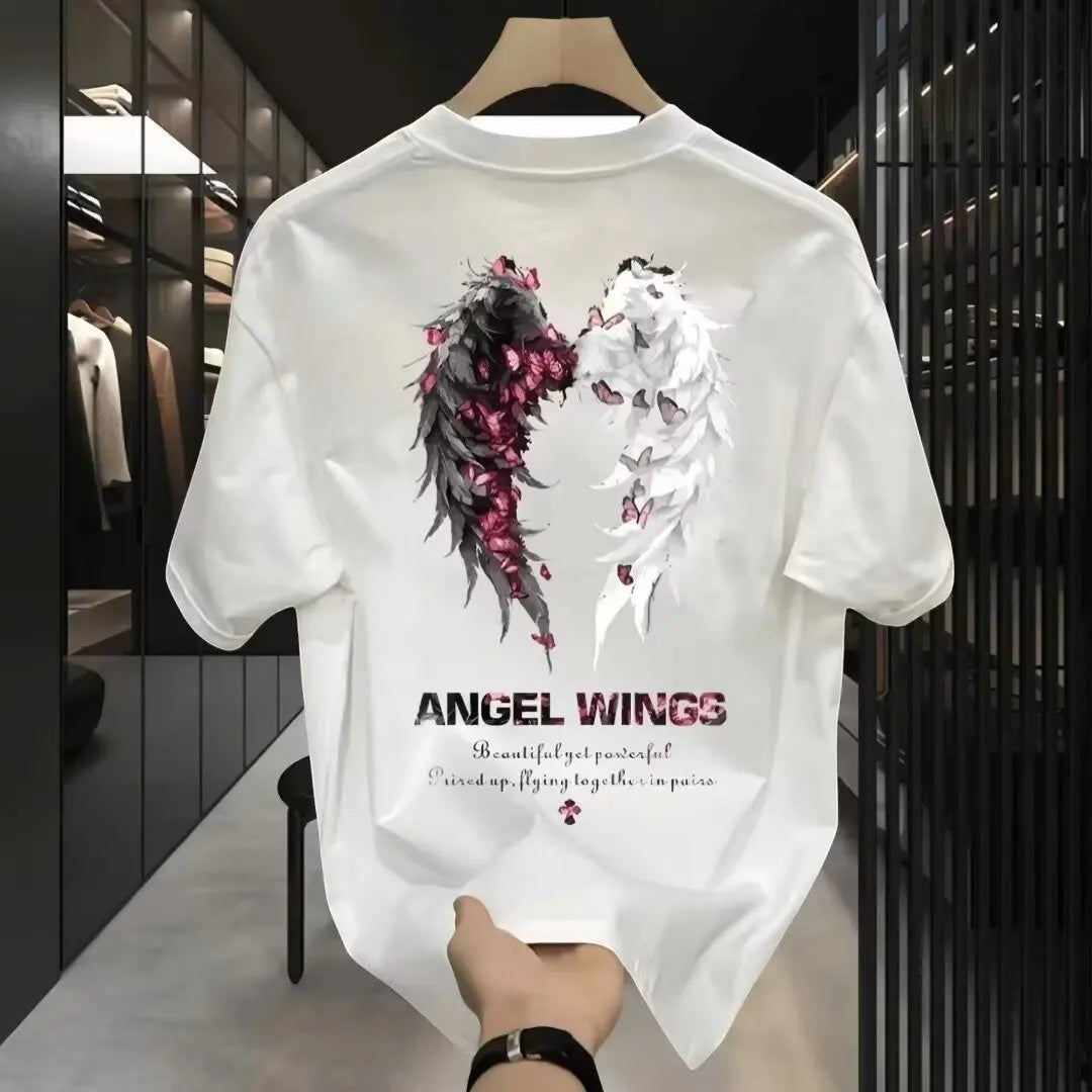 COMFORTH Angel Wings graphic t-shirt in white cotton with black and white wings design, accented with pink flowers and butterflies.