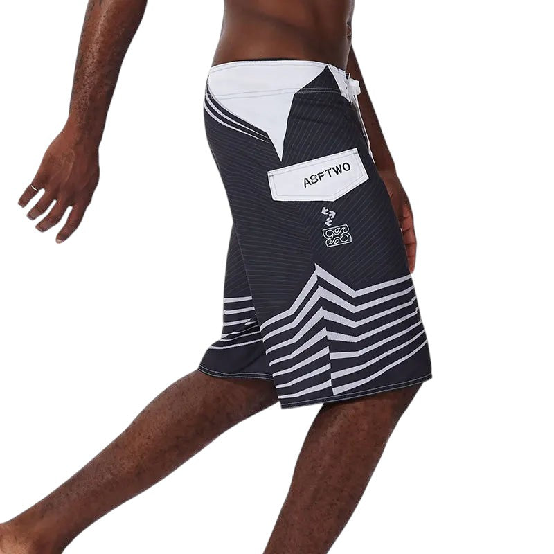 COMFORTH Men's athletic black and white striped board shorts with drawstring closure and pocket.