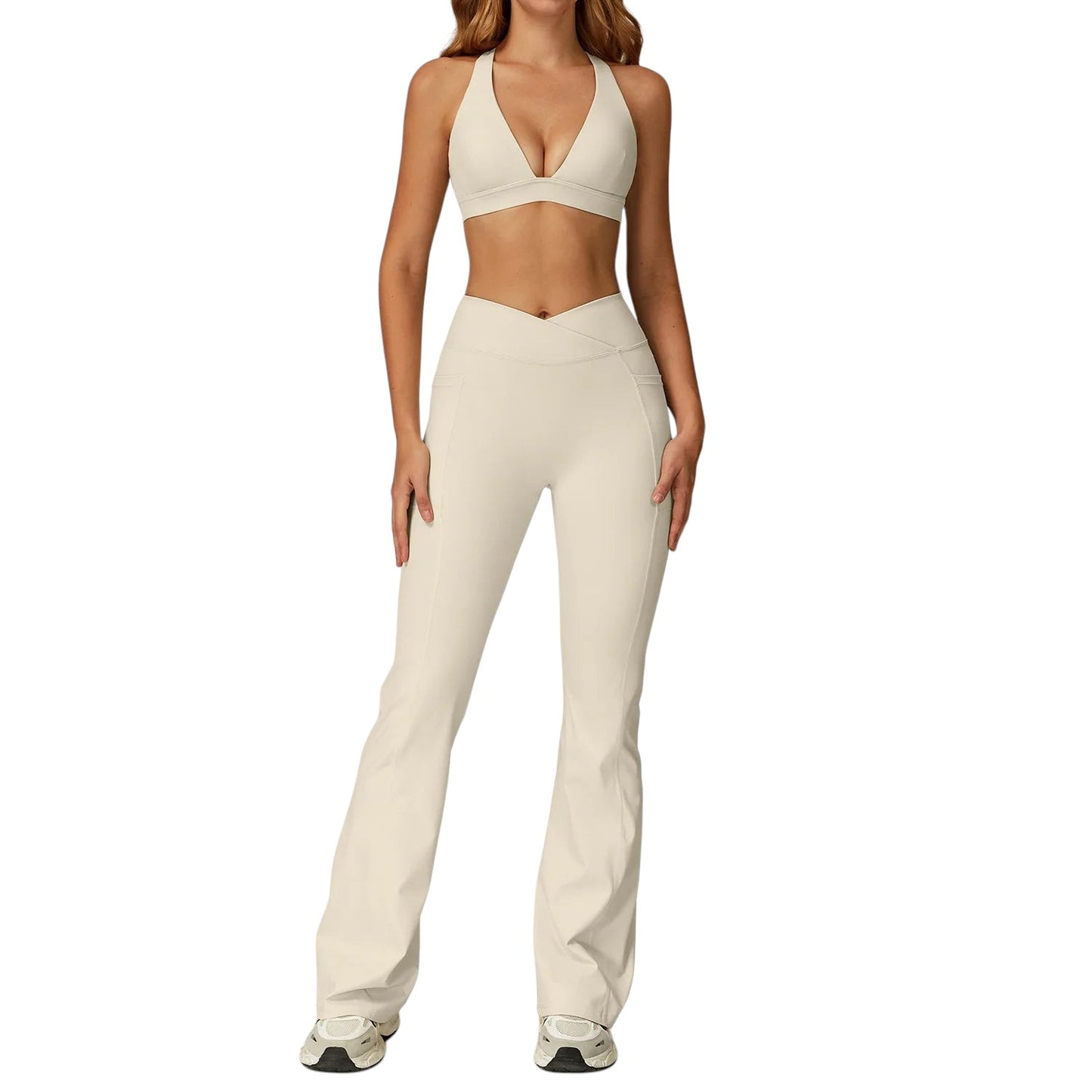 COMFORTH women's athletic two-piece set with cream halter-neck sports bra and V-waist flare leggings.