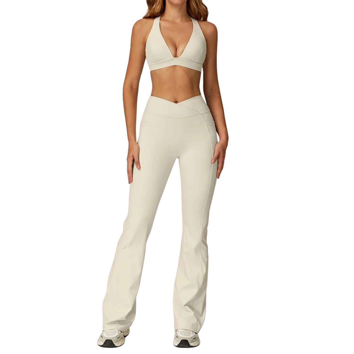 COMFORTH women's athletic two-piece set with cream halter-neck sports bra and V-waist flare leggings.
