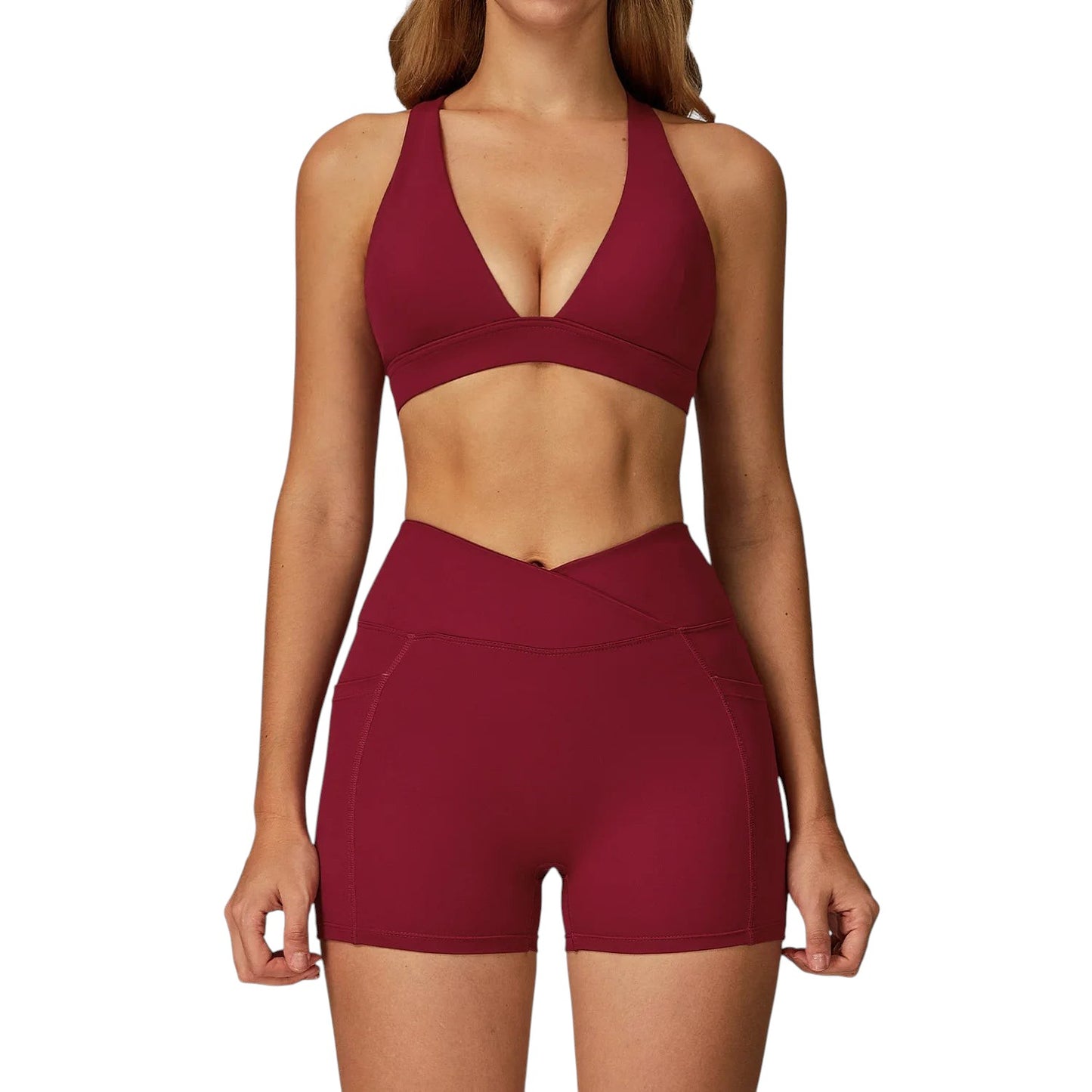 COMFORTH women's athletic two-piece set in deep red, featuring a halter neck V-neck sports bra and high-waisted shorts with a V-shaped waistband.