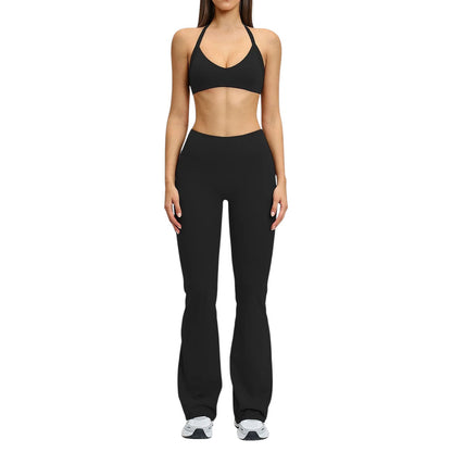 COMFORT black high-waisted flare yoga pants on a woman, made of stretchy fabric.