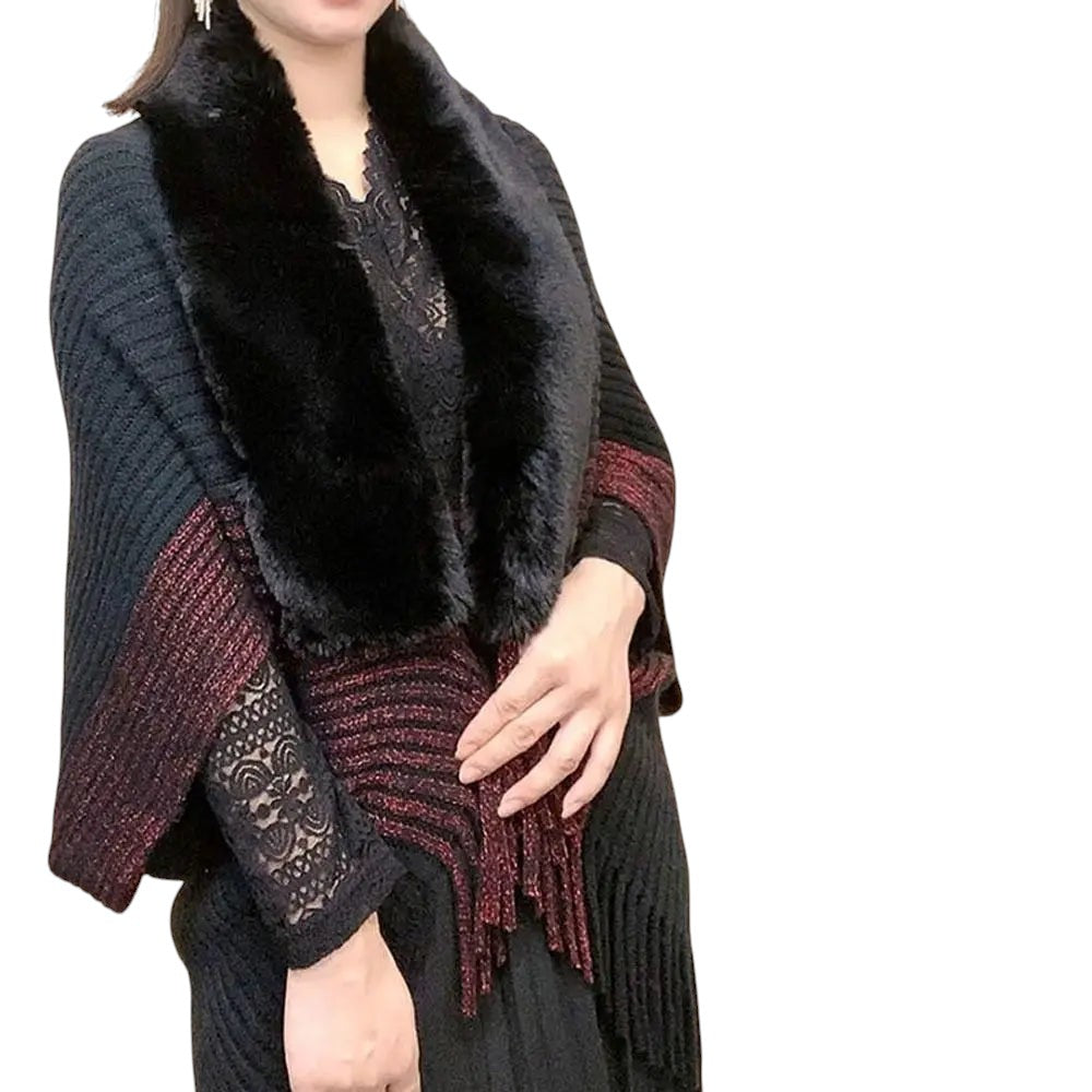 COMFORTH black knit poncho wrap with faux fur collar and red fringe detail