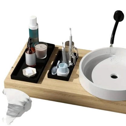COMFORTH black rectangular resin tray with marble finish, holding soap dispenser, candle, and toiletries.