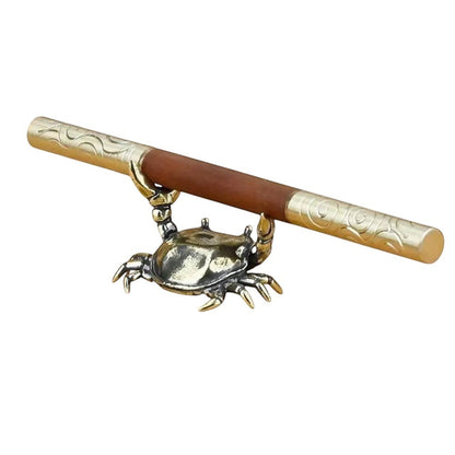 COMFORTH antique brass crab pen holder stand with detailed legs and shell, holding a wooden pen.