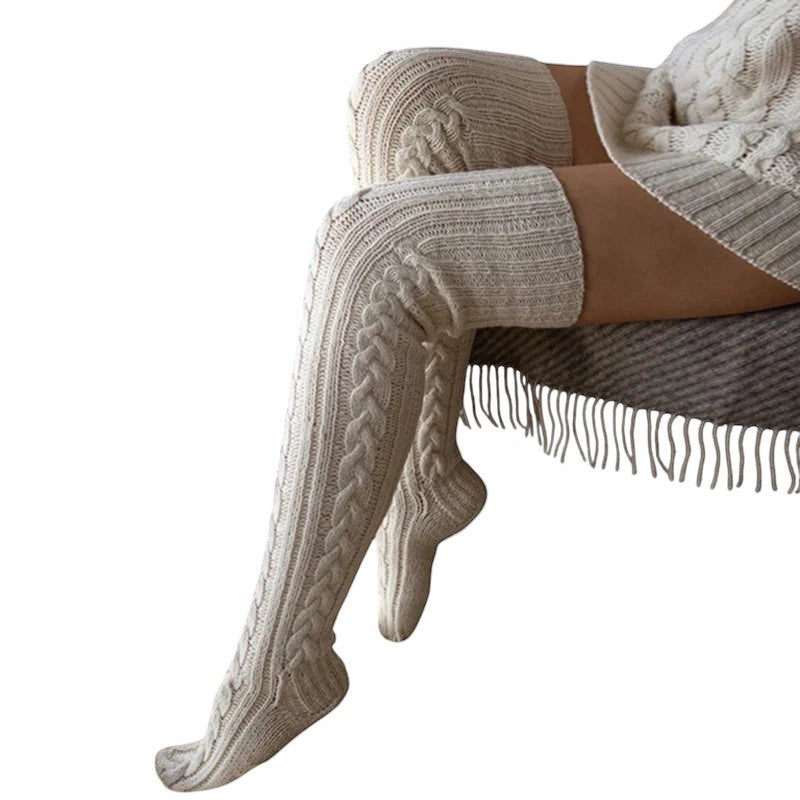 COMFORTH cable knit thigh high socks in cream. Soft, warm, and cozy knit socks with a classic cable pattern.