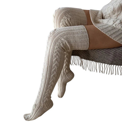 COMFORTH cable knit thigh high socks in cream. Soft, warm, and cozy knit socks with a classic cable pattern.