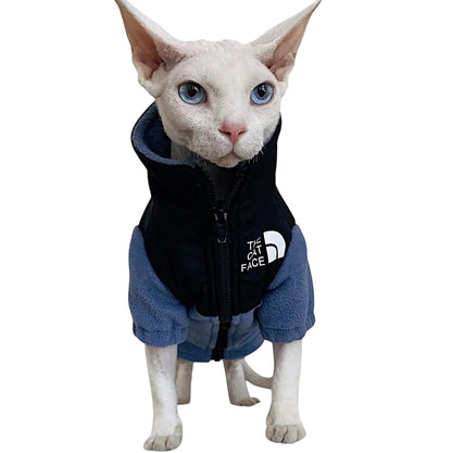 COMFORTH The Cat Face Fleece Pet Jacket in black and blue, designed for Sphynx cats. Features a zipper closure and high collar.