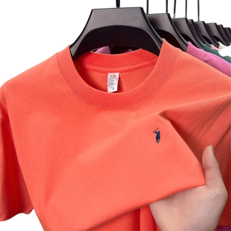 COMFORT crew neck short sleeve t-shirt in coral orange with embroidered navy blue logo on chest. Soft cotton blend.