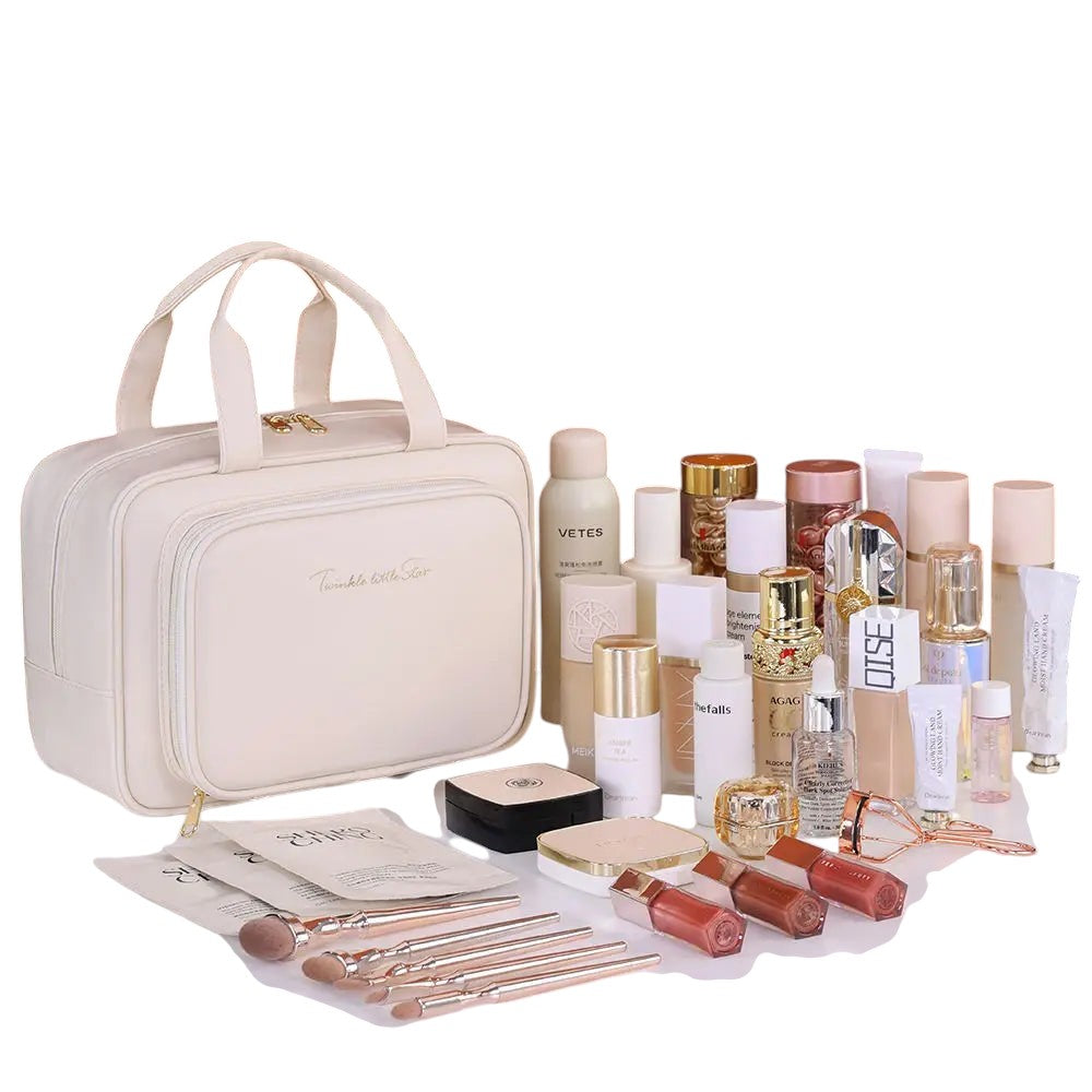 COMFORT cream PU leather travel makeup bag organizer with gold zipper and "Twinkle little Star" embroidery. Includes makeup brushes and cosmetics.