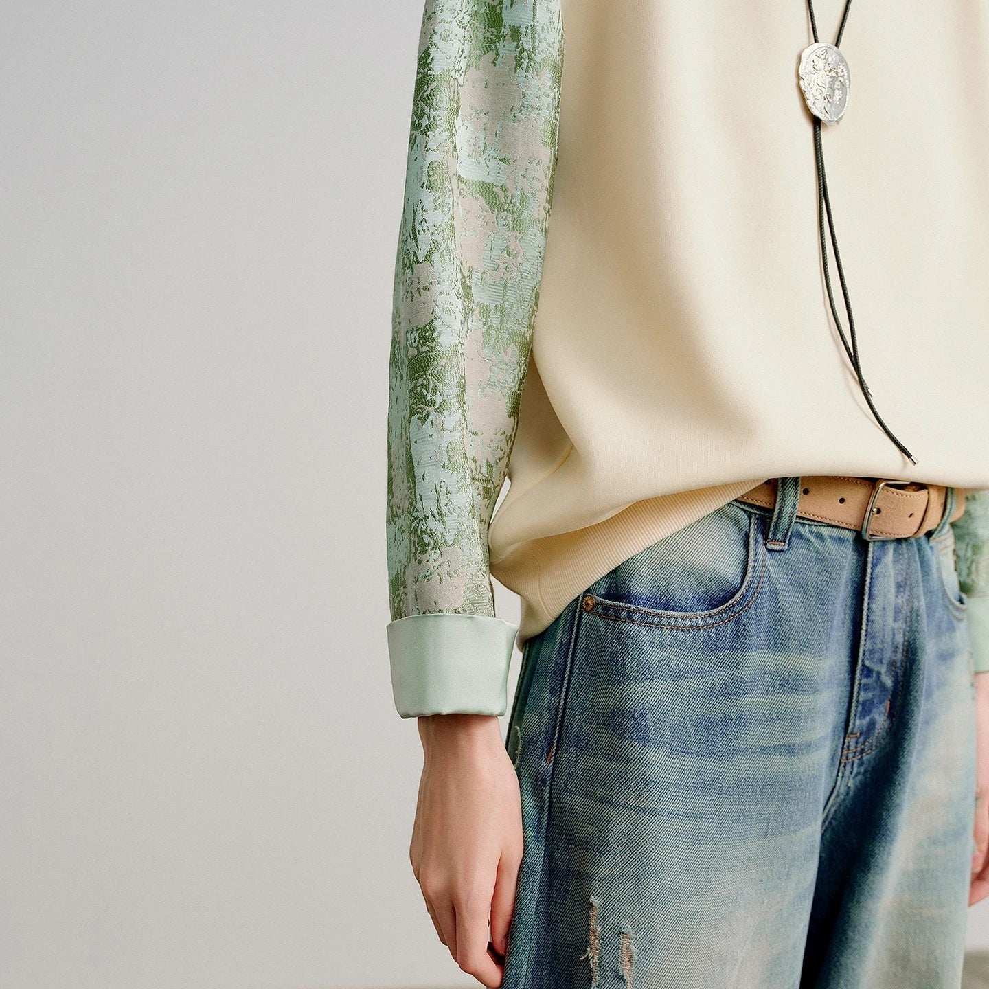 COMFORTH crew neck sweatshirt in cream cotton blend with textured sage green contrasting sleeves and ribbed cuffs.