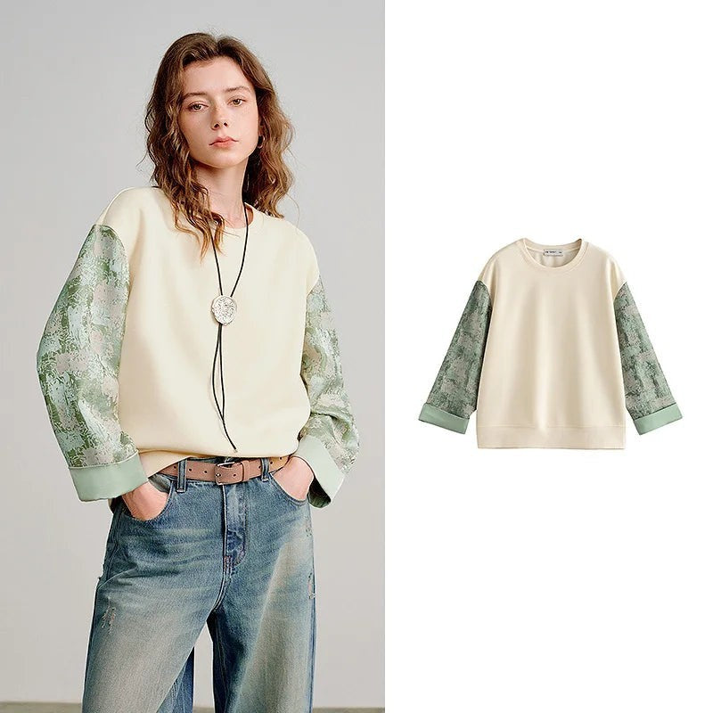 COMFORTH cream cotton blend crew neck sweatshirt with textured sage green contrasting sleeves and ribbed cuffs.