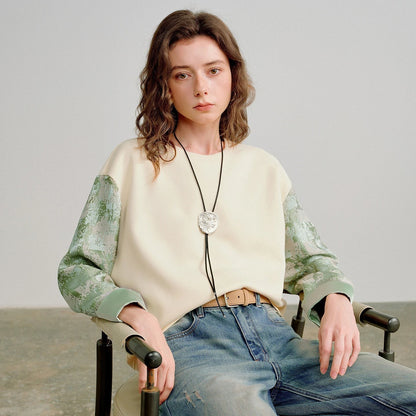 COMFORTH cream cotton blend crew neck sweatshirt with textured sage green contrasting sleeves and ribbed cuffs.