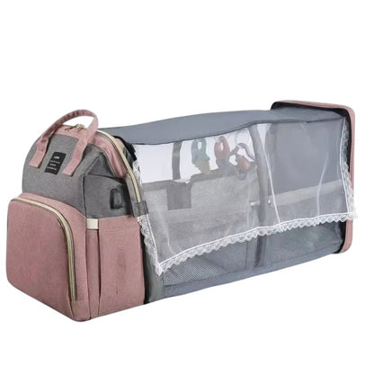 COMFORT gray and pink diaper bag backpack with expandable bassinet, mesh canopy, and toys.