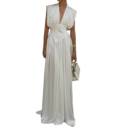 COMFORTH elegant ivory sleeveless deep V-neck maxi dress with flowing fabric and gathered bodice.