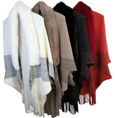 COMFORTH faux fur trimmed knit poncho wrap with fringe detail in cream, taupe, black, and red.