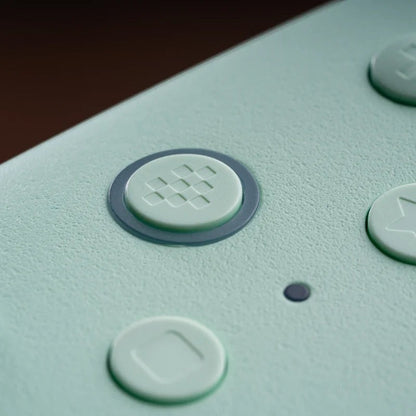 COMFORTH gaming controller in pastel mint with textured finish and responsive buttons.