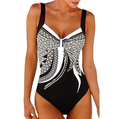 COMFORTH women's one-piece swimsuit with geometric print in black, white, and tan. Features adjustable straps and a bow detail.