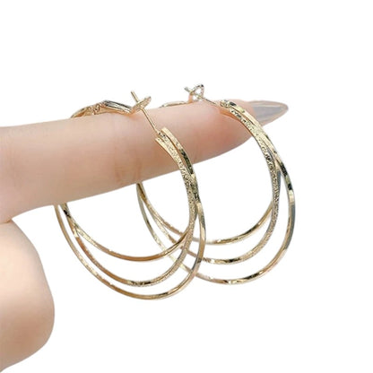 COMFORTH elegant gold multi-layered hoop earrings with textured finish. Lightweight metal, perfect for day or evening wear.