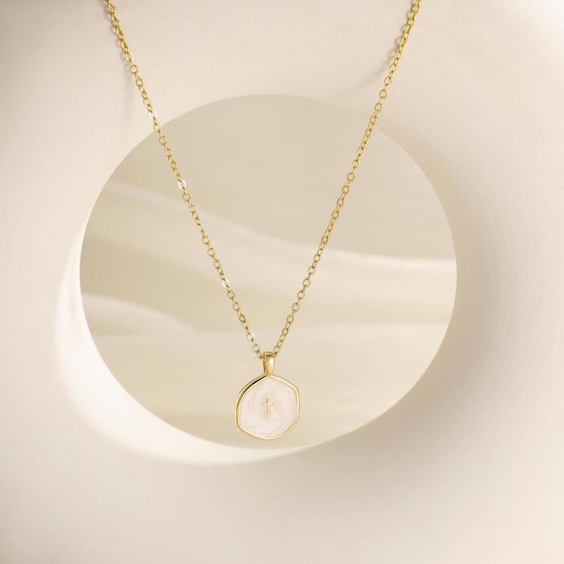 COMFORTH Gold plated necklace with a unique irregular pendant featuring a subtle cross inlay on creamy white material.