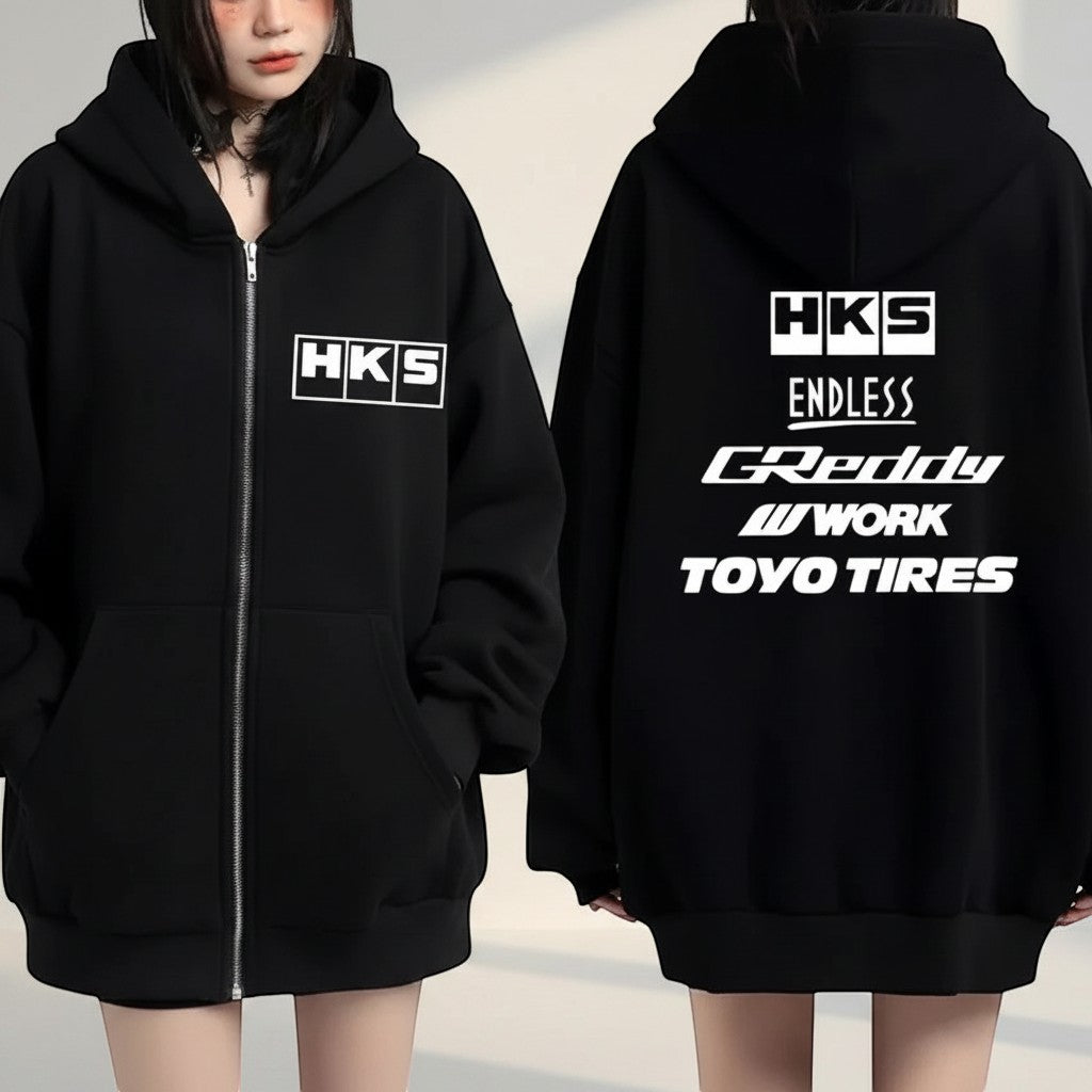 COMFORTHKS graphic zip-up hoodie in black with multiple brand logos on front and back. Features a full zip, hood, and pockets.