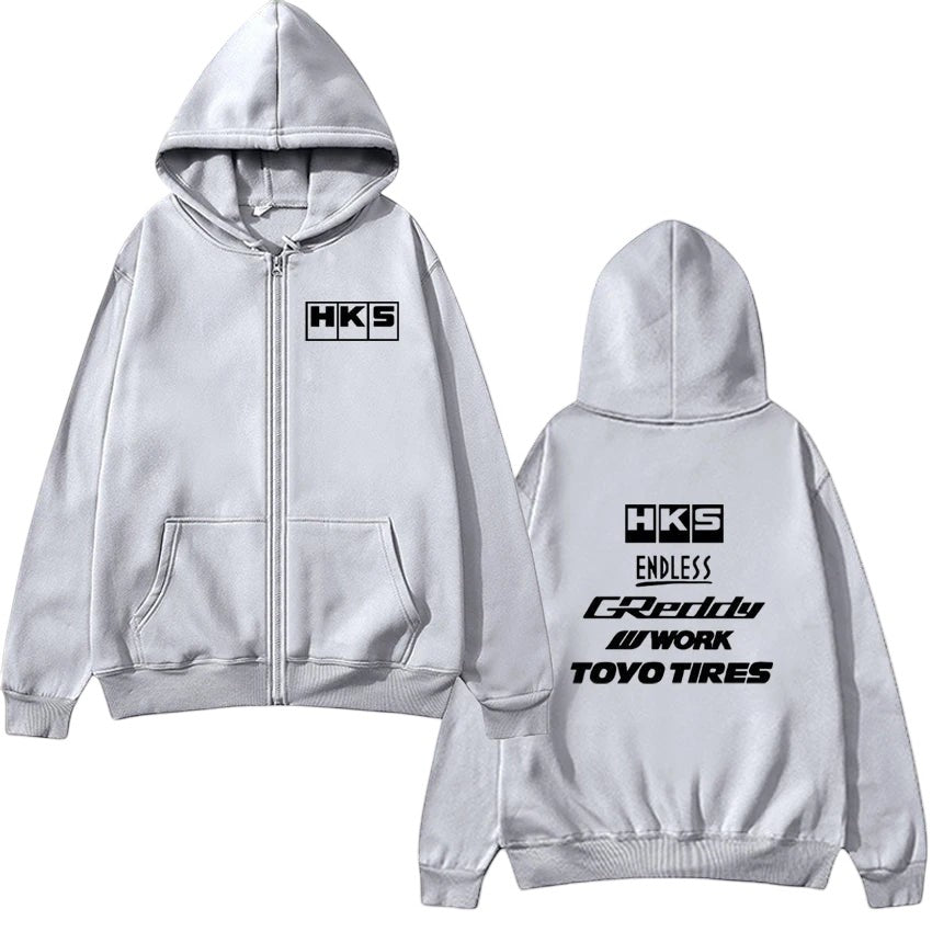 COMFORT grey zip-up hoodie with HKS logo on front and multiple brand logos on back. Casual streetwear style.