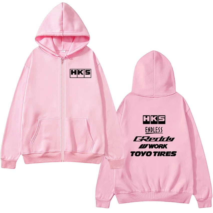 COMFORTHKS graphic zip-up hoodie in pink with multiple brand logos on front and back. Features a full zip, hood, and pockets.