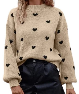 COMFORT beige knit sweater with black heart pattern, long sleeves, crew neck, and relaxed fit.