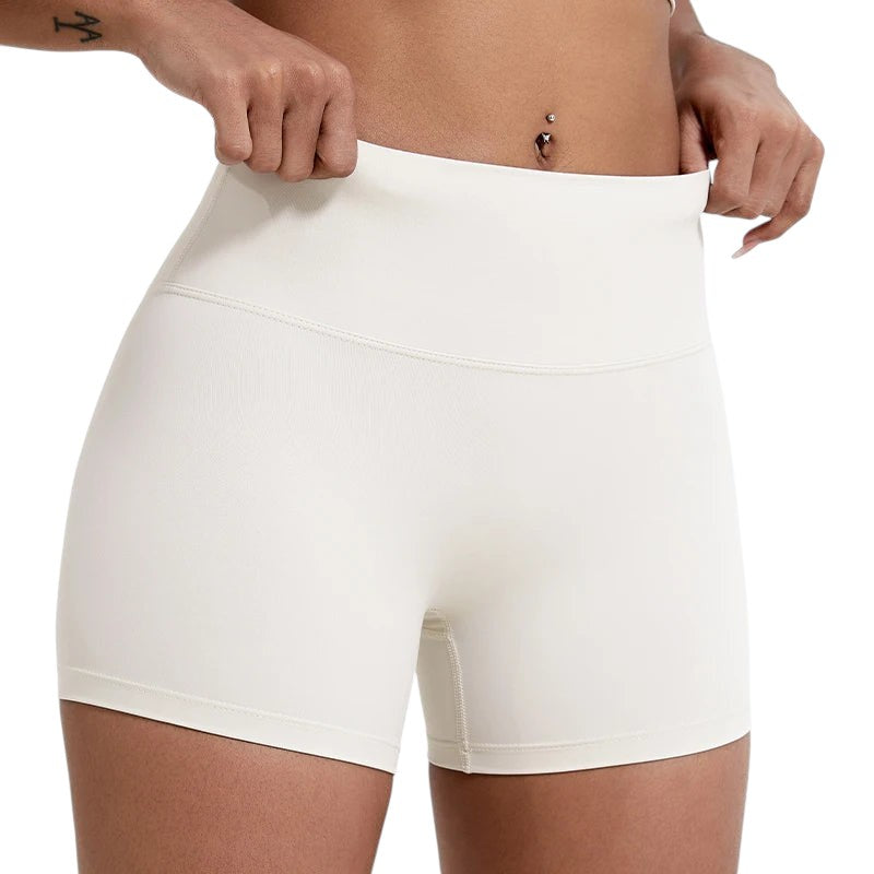 COMFORTHere white high-waisted athletic shorts for women, seamless design, tummy control, four-way stretch fabric.