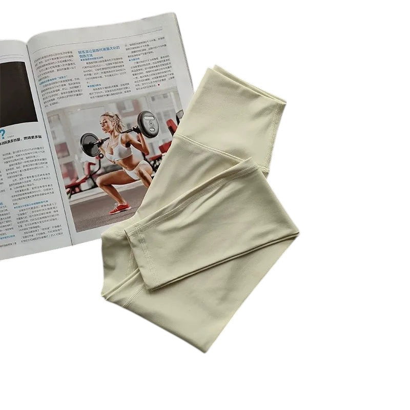 COMFORT women's high-waisted light yellow activewear leggings made of soft, stretchy fabric.