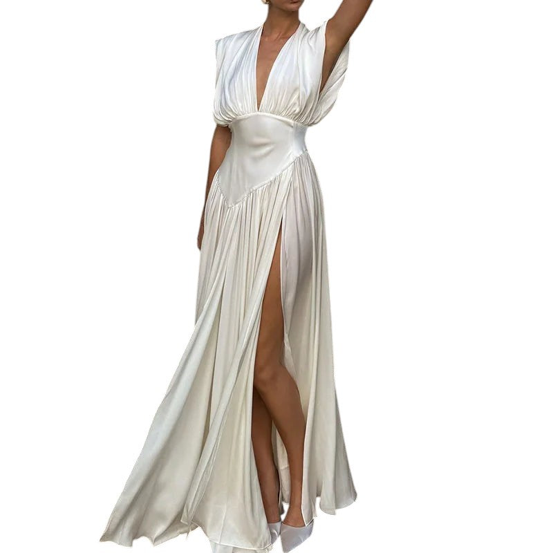 COMFORTH Ivory satin sleeveless deep V-neck maxi dress with high slit and flowing skirt.
