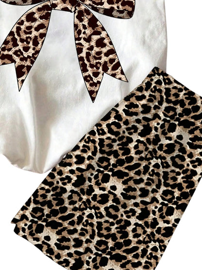 COMFORTH white t-shirt with leopard print bow graphic and matching leopard print shorts. Cotton set for kids.