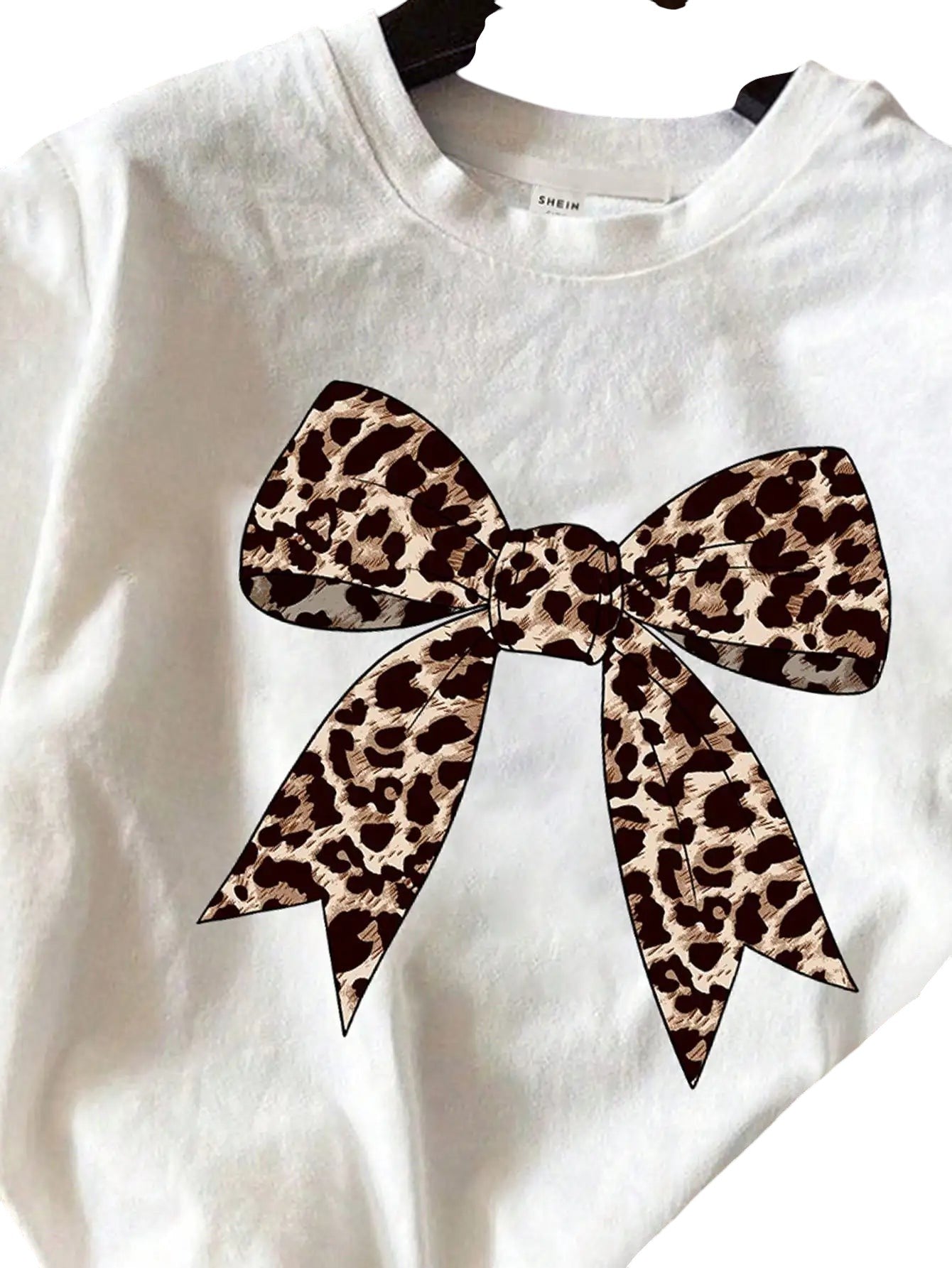COMFORTH white cotton t-shirt with leopard print bow graphic. Part of a matching set.