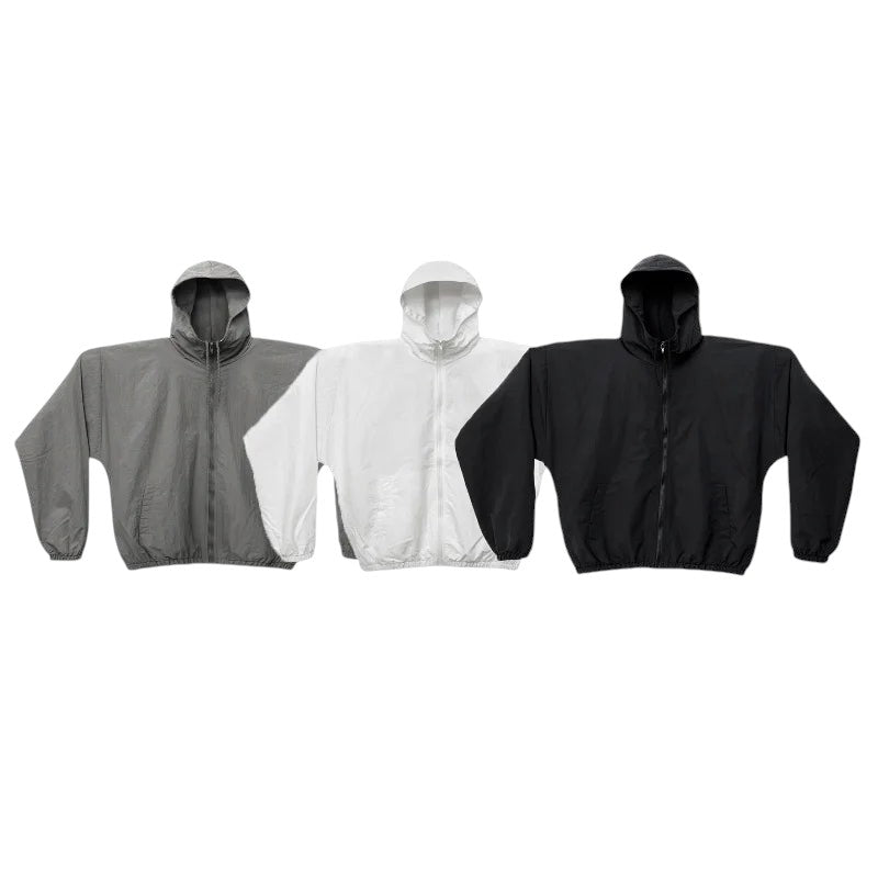 COMFORTH three lightweight hooded jackets in grey, white, and black with zipper closure and elasticated cuffs.