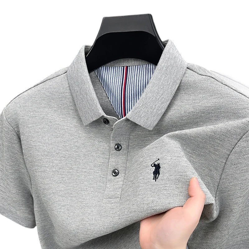 COMFORTH Men's grey pique knit short sleeve polo shirt with embroidered logo and striped inner collar detail.
