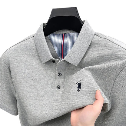 COMFORTH Men's grey pique knit short sleeve polo shirt with embroidered logo and striped inner collar detail.