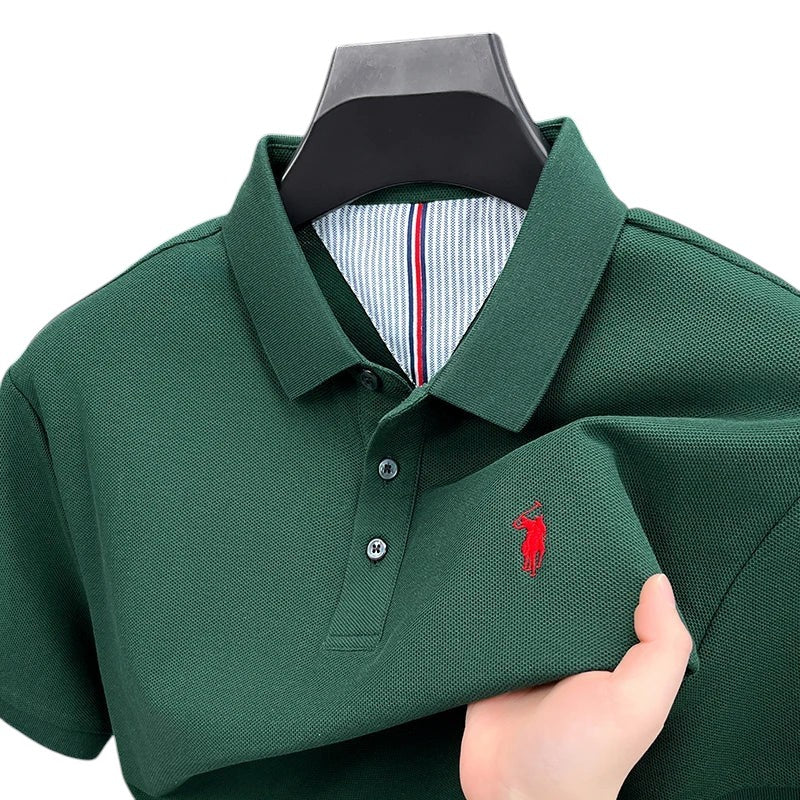 COMFORTH Men's short sleeve dark green pique knit polo shirt with red embroidered logo and striped inner collar.