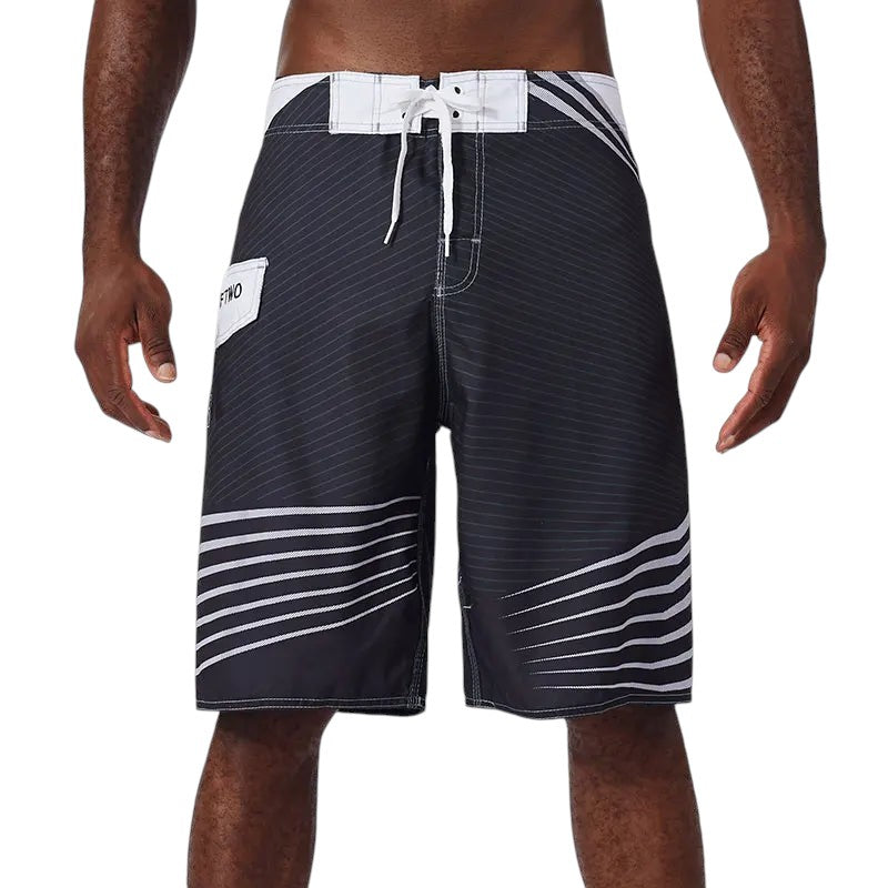 COMFORTH Men's black and white striped athletic board shorts with drawstring closure and side pocket.
