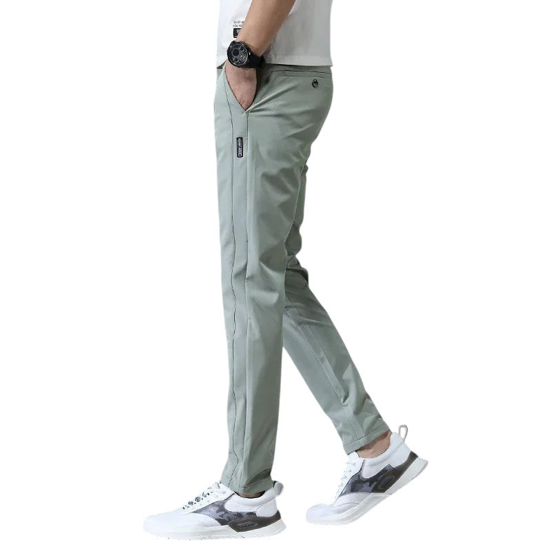 COMFORTH Men's light green casual stretch chino pants with slim fit and side logo tag.