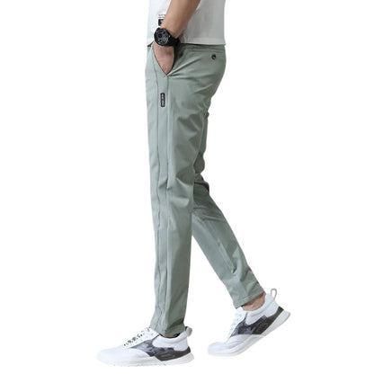 COMFORTH Men's light green casual stretch chino pants with slim fit and side logo tag.